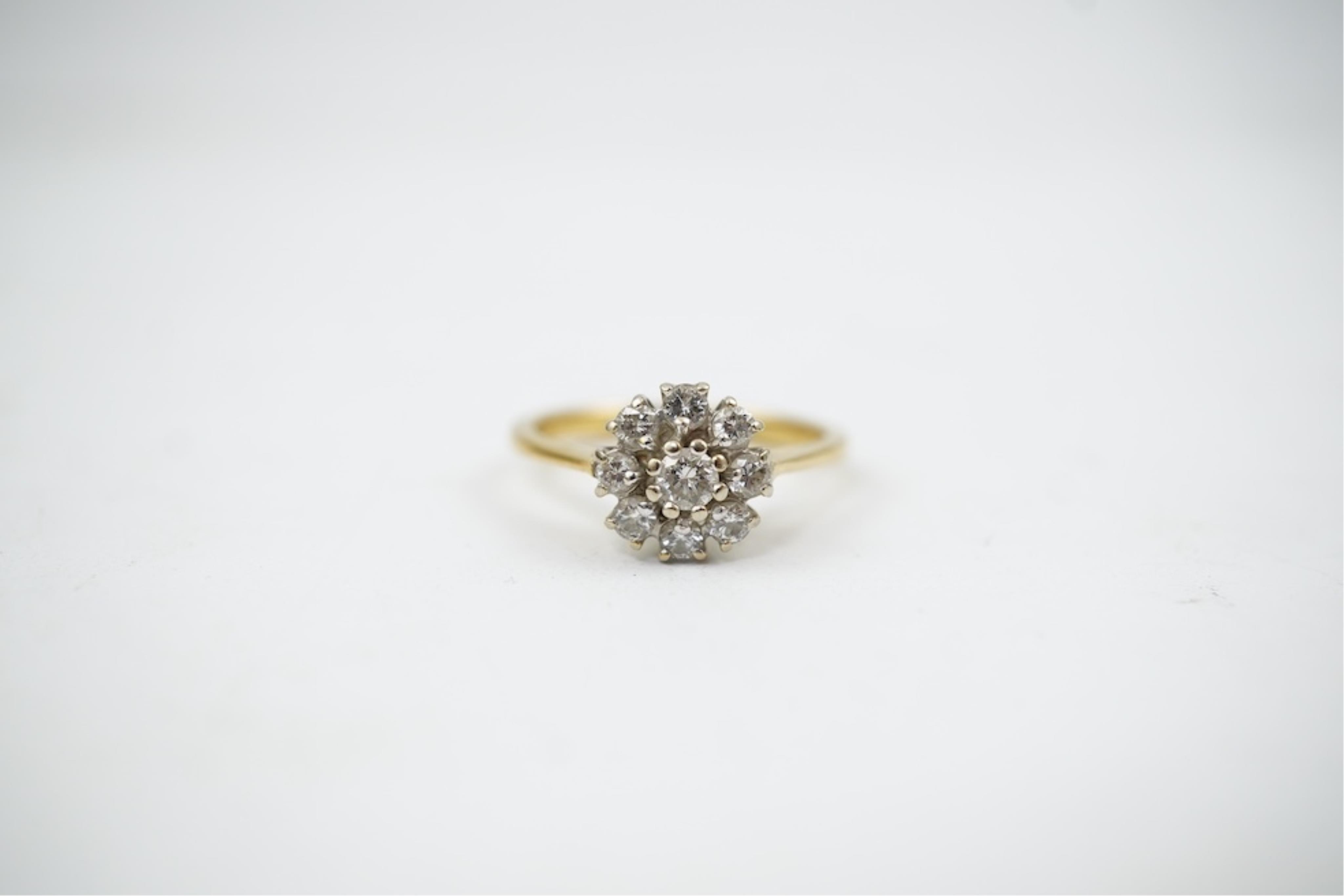 A modern 18ct gold and diamond set circular cluster ring, size M, gross weight 3.2 grams.